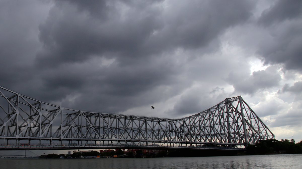 Dark monsoon clouds loom over Howrah Bridge in Kolkata