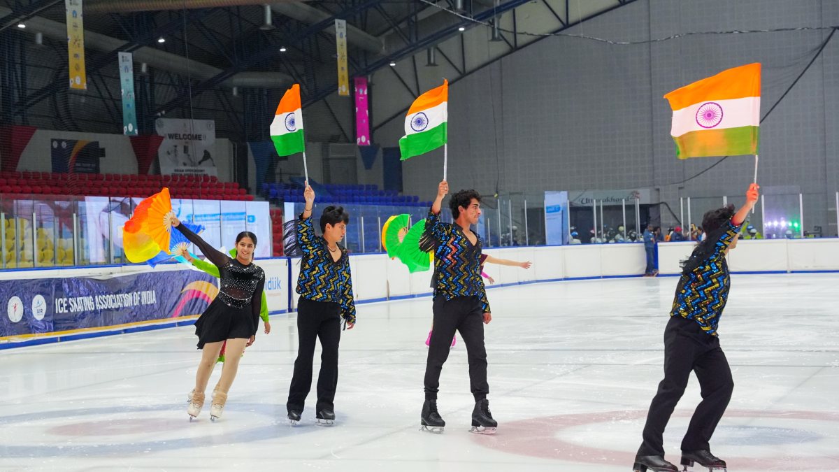 Ice skaters hold the national flag in action at Himadri Ice Rink at Maharana…