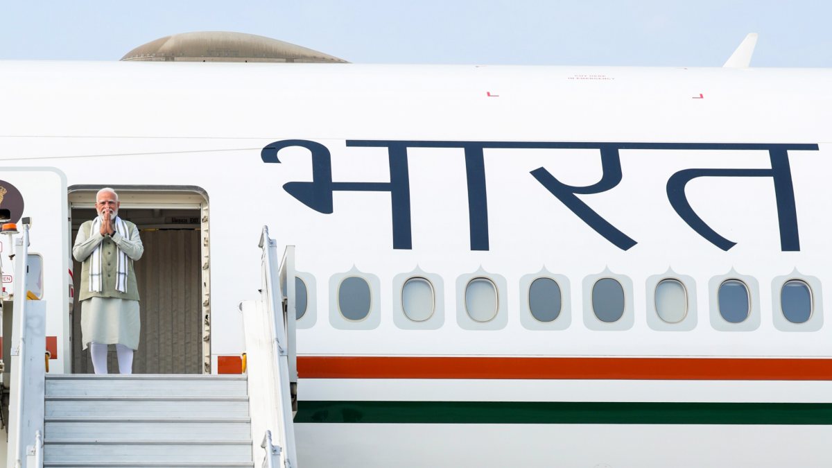 Prime Minister Narendra Modi greets as he emplanes for Jakarta, commencing his…