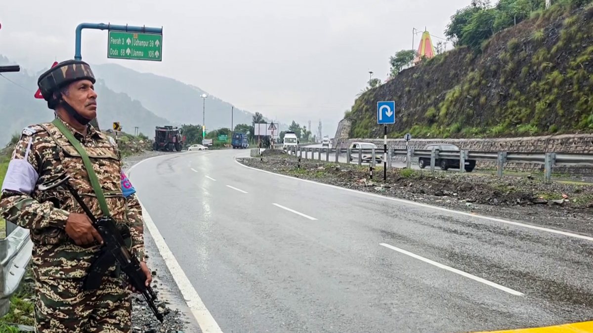 Security personnel guard Amarnath Yatra convoy on rain-soaked highway