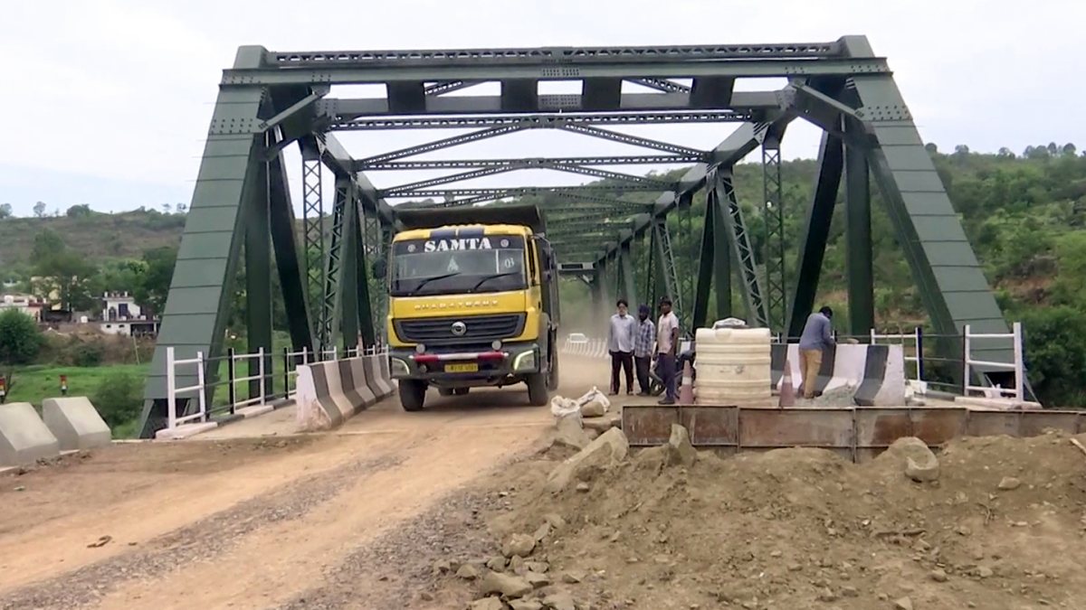 A vehicle passes through the newly opened first permanent steel Jambhir Bridge…