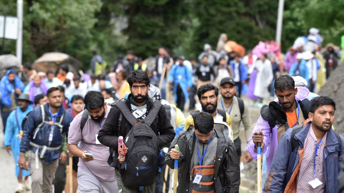 Pilgrims cross mountain trail on Pahalgam route during Amarnath Yatra