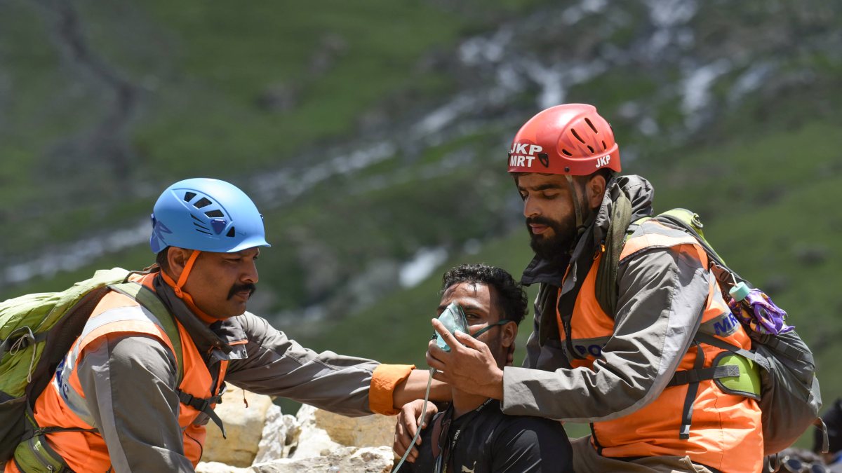 JKP MRT officials give oxygen to a pilgrim as he crosses a mountain trail via…