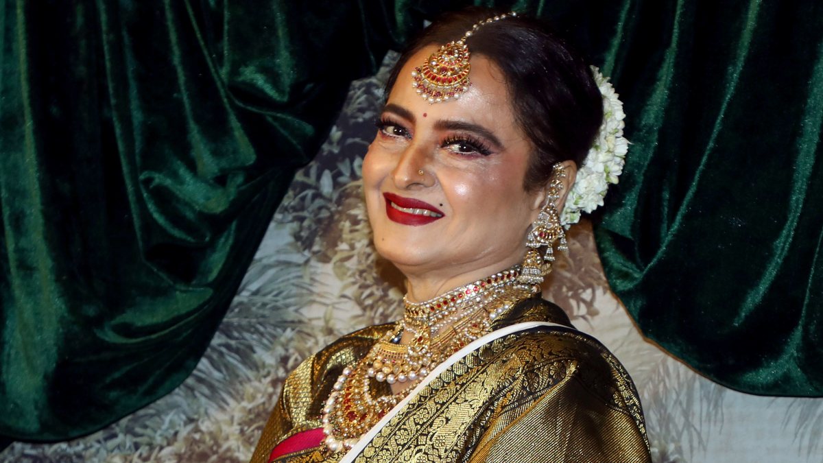 Bollywood actress Rekha poses for a photograph during the wedding reception of…