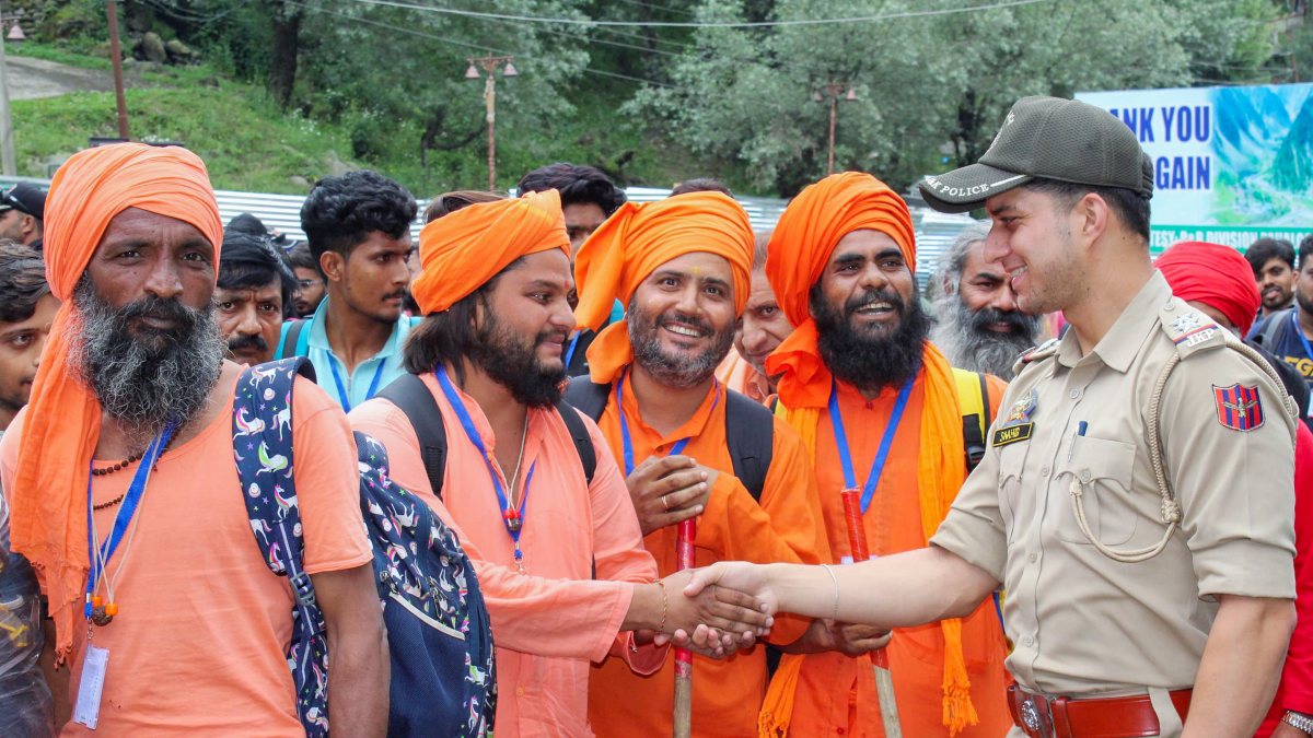 Jammu and Kashmir Police personnel assist yatris at the Nunwan base camp, in…