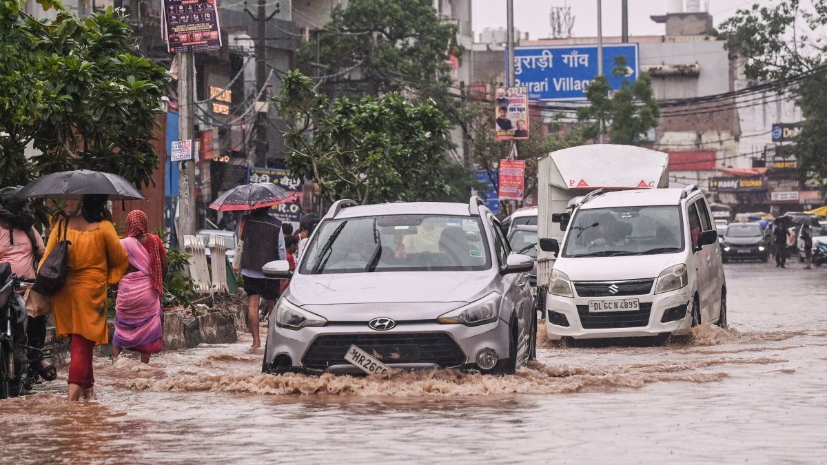 Vehicles wade through waterlogged road in Delhi's Burari