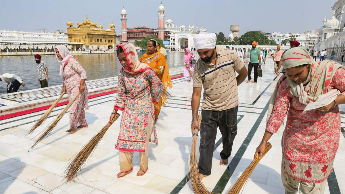 Devotees perform 'Sewa' by brooming the circumambulatory of the Golden Temple…