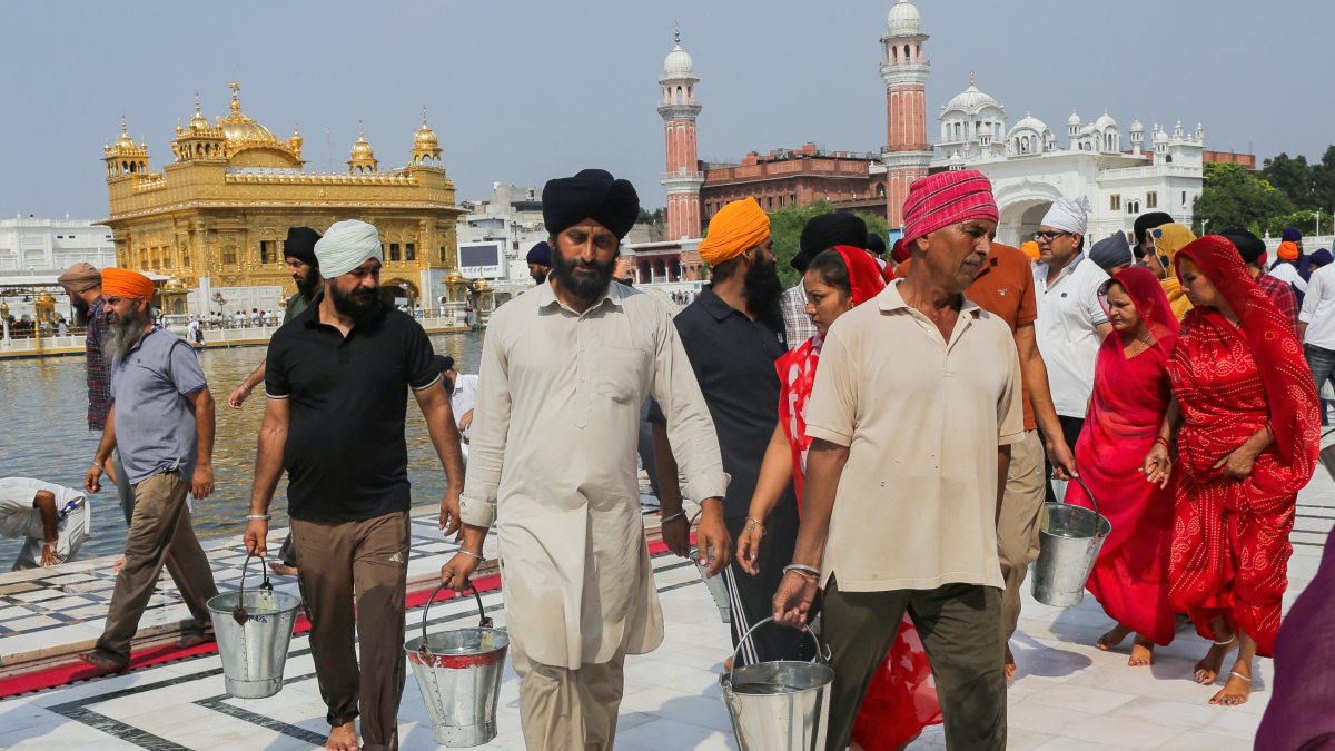 Devotees clean Golden Temple circumambulatory with holy water