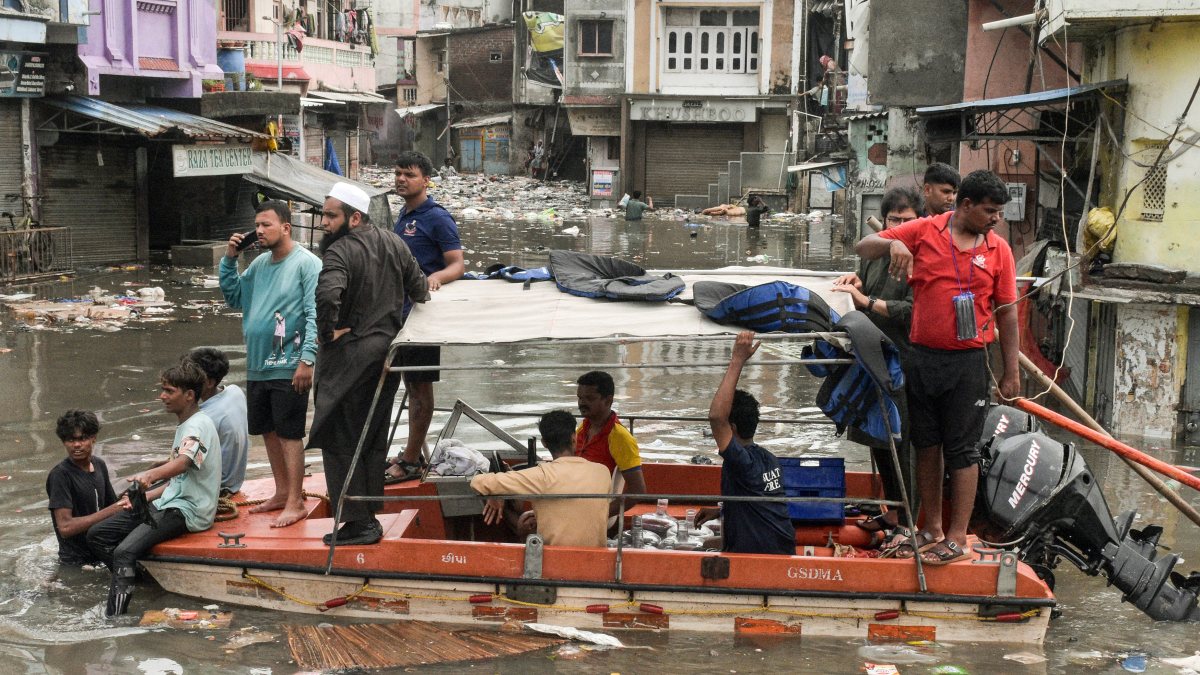 People evacuated by boat in Surat's waterlogged Limbayat Meethi Khadi area