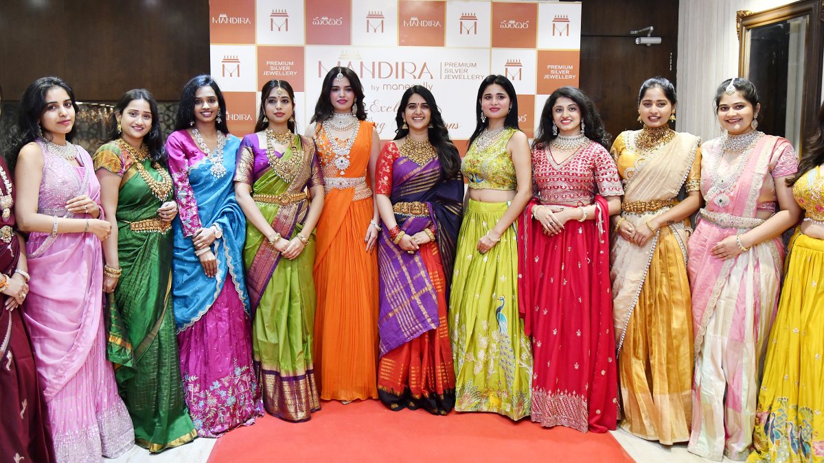 Models wearing jewellery pose for a picture during the launch of a premium…