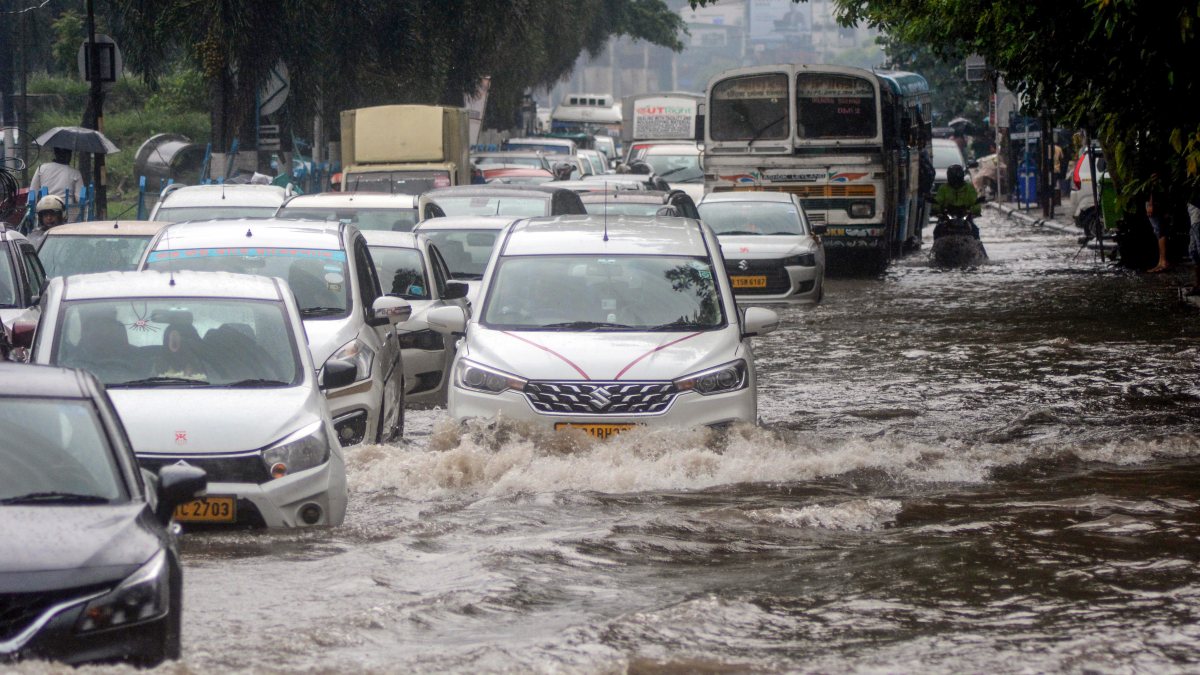 Vehicles wade through waterlogged Kolkata streets after heavy rain