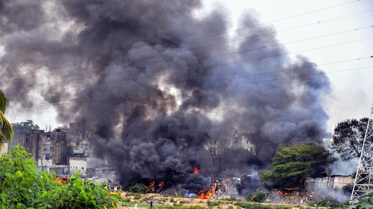 Dark smoke and flames billow out after a fire breaks out in a godown storing…