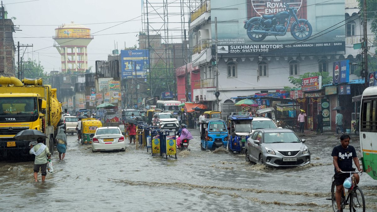 Commuters navigate waterlogged road amid Patna rainfall