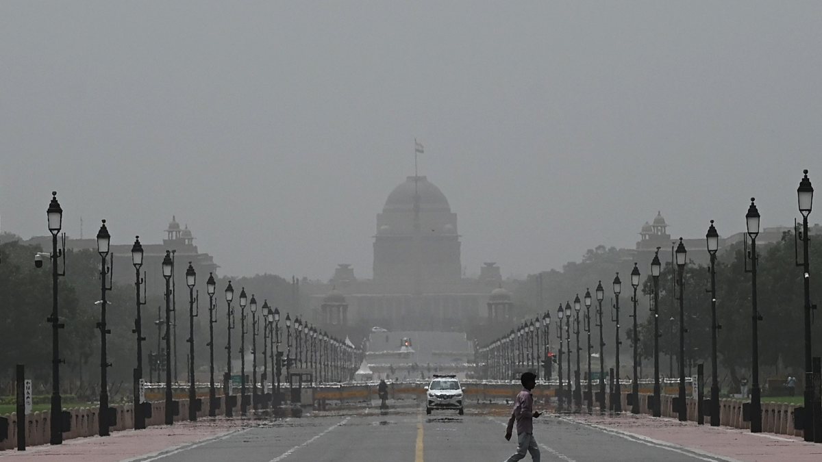 Man walks on Kartavya Path amid reduced visibility in Delhi