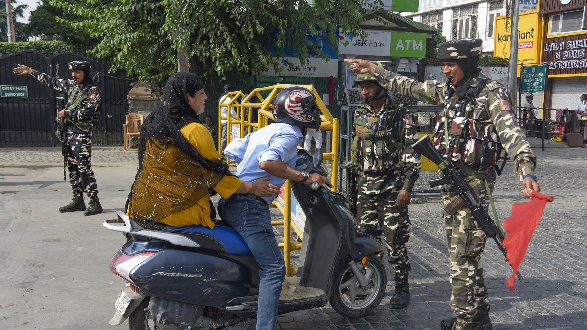 SSB personnel stop commuter at barricade on Martyrs' Day in Srinagar
