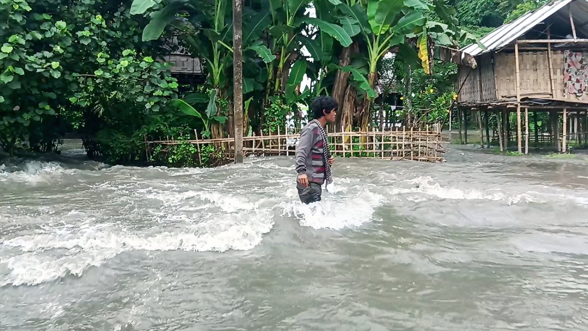 Villager walks through waterlogged area after Assam floods