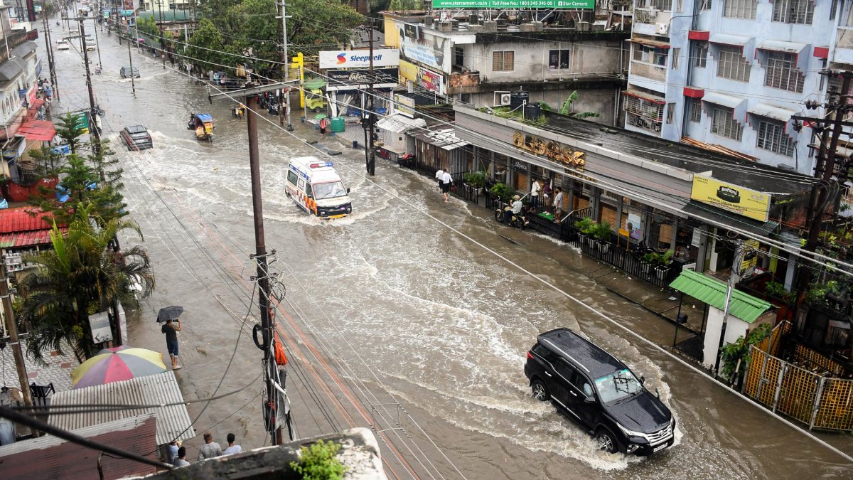 Vehicles wade through waterlogged street after heavy rain in Guwahati