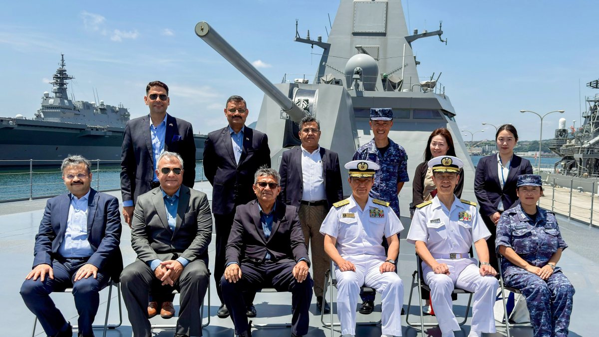 Defence secretary poses with Japanese crew on Mogami-class frigate