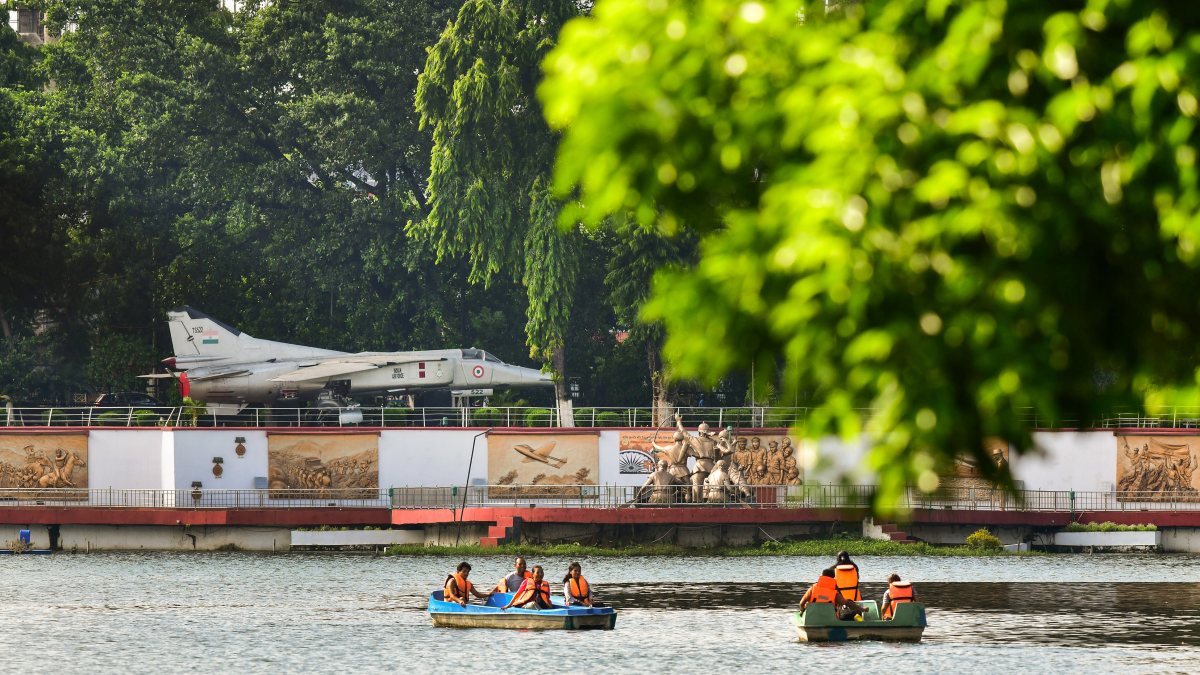 People enjoy boating on a hot summer evening at Guwahati's historic Dighalipukhuri lake