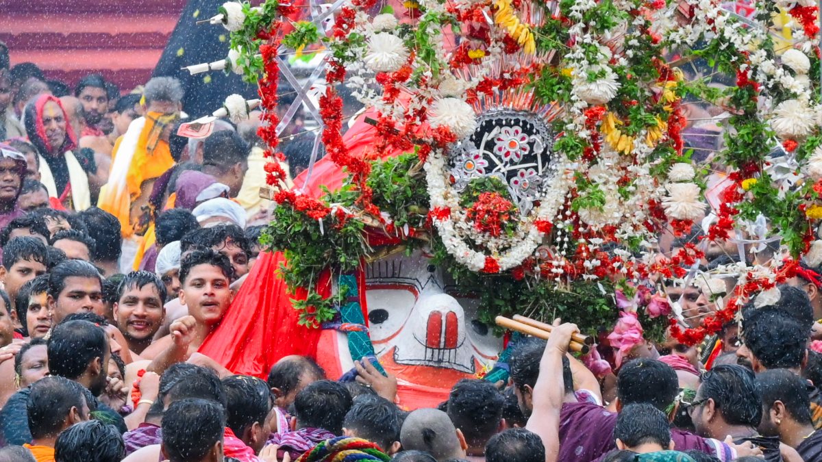Devotees carry Lord Balabhadra to chariot at Puri Rath Yatra