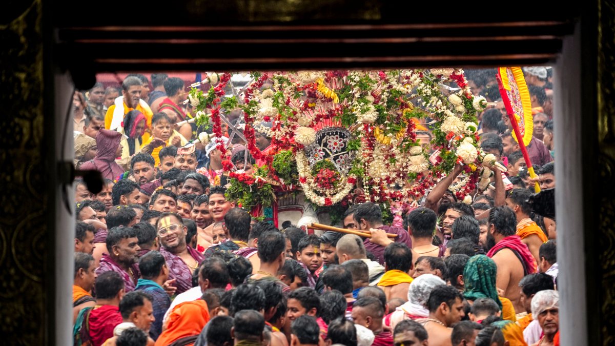 Devotees carry Lord Balabhadra to Taladhwaja Ratha in Puri