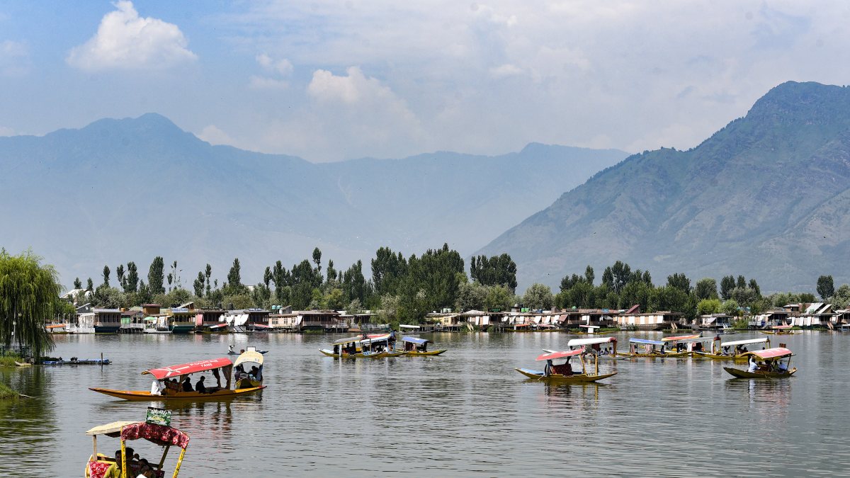 Tourists enjoy Shikara ride on Dal Lake in Srinagar heat