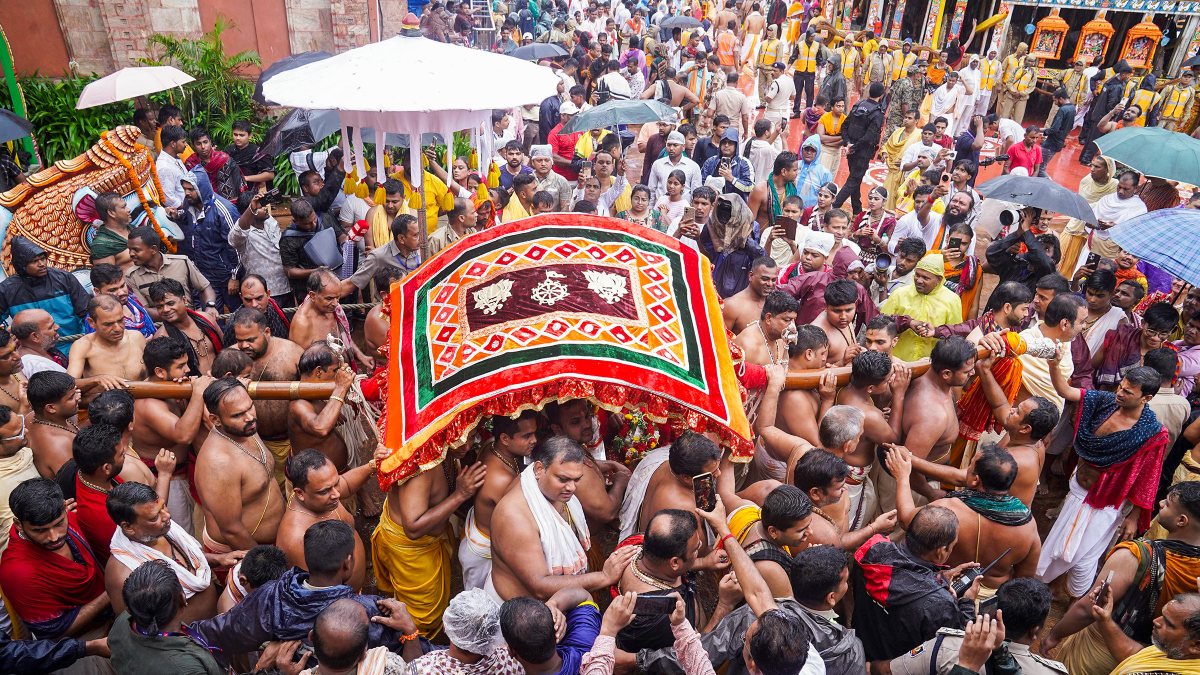 Devotees carry palanquin during Puri Rath Yatra
