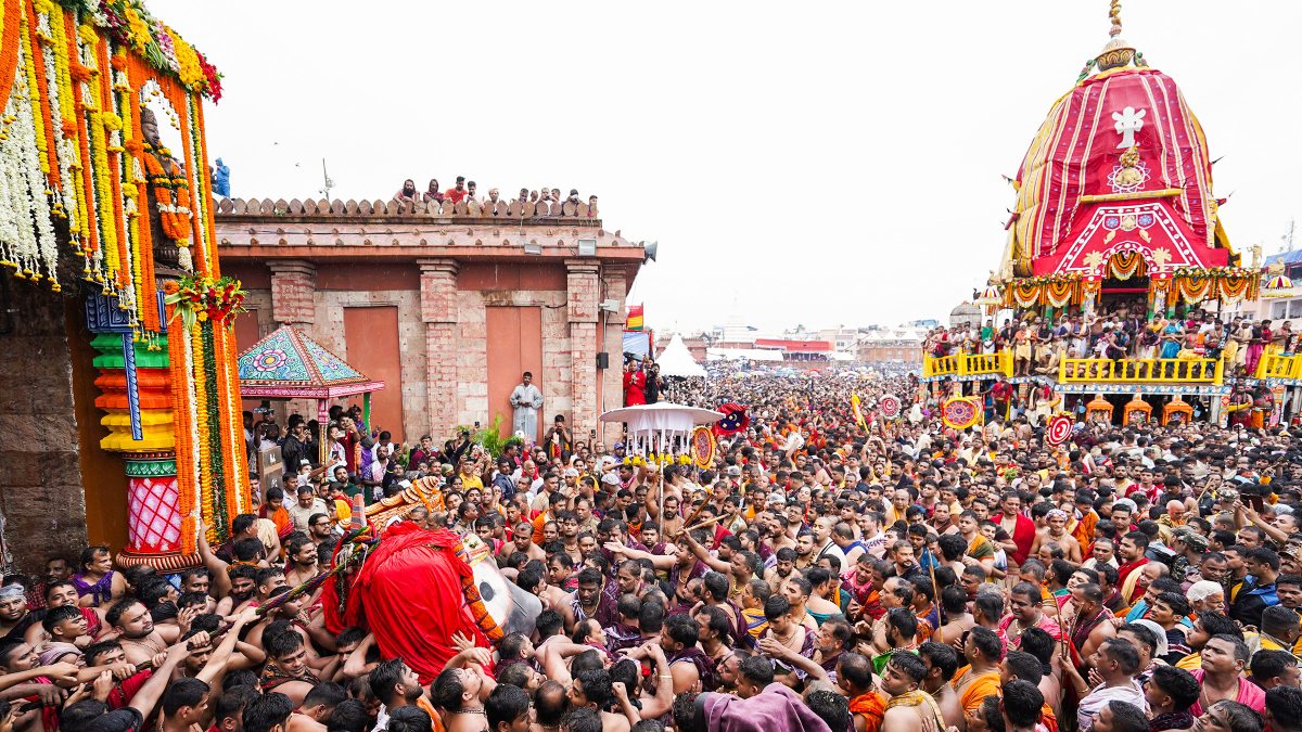 Devotees carry Lord Jagannath to chariot during Puri Rath Yatra