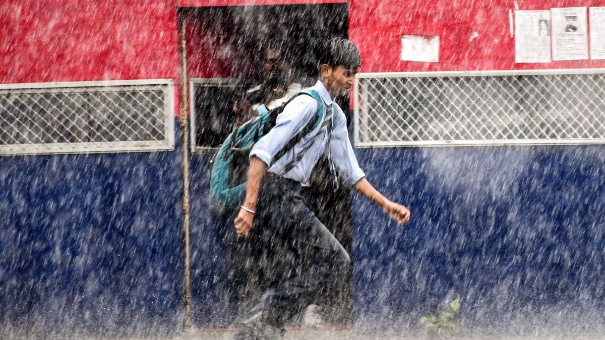 Student runs through heavy rain in Prayagraj