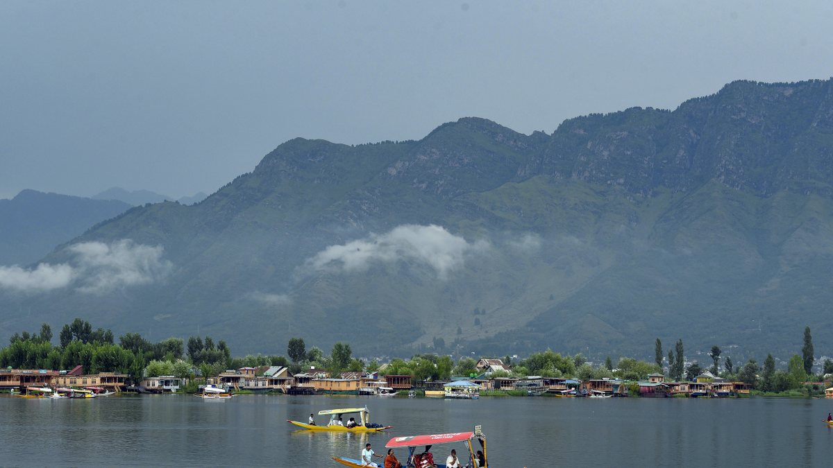 Tourists enjoy Shikara ride after heavy rainfall in Srinagar
