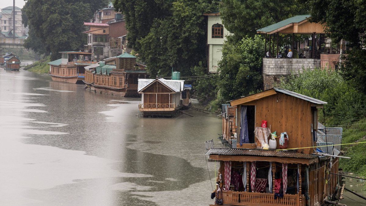 Houseboats anchored along Jhelum River amid heavy rain in Srinagar