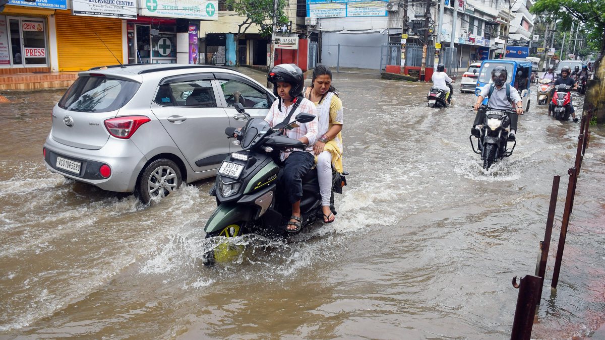 Vehicles wade through waterlogged road in Guwahati after heavy rain