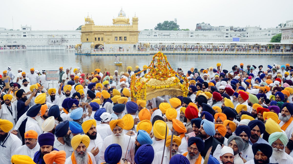 Sikh devotees carry Guru Granth Sahib in golden palanquin at Miri Piri March