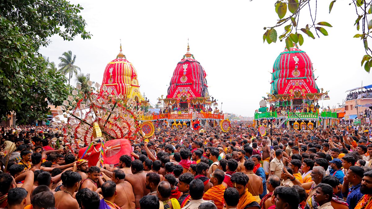 Devotees carry Lord Shri Jagannath from the chariot towards the temple during…