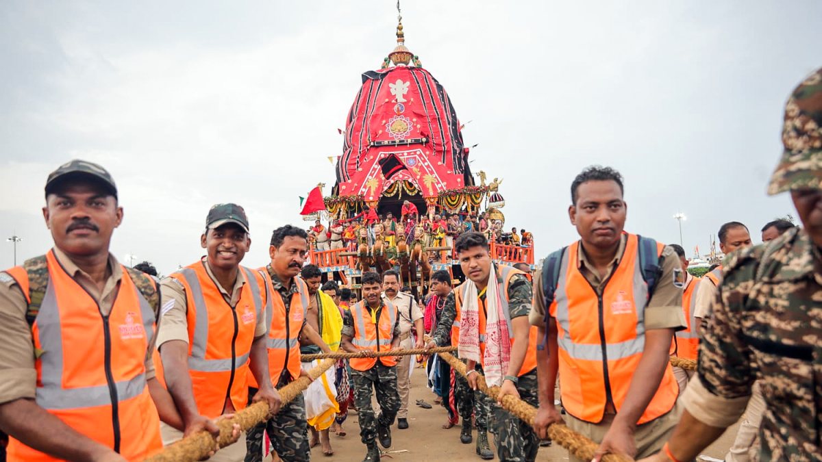 Security personnel pull the rope of the chariot as they take part in Bahuda…