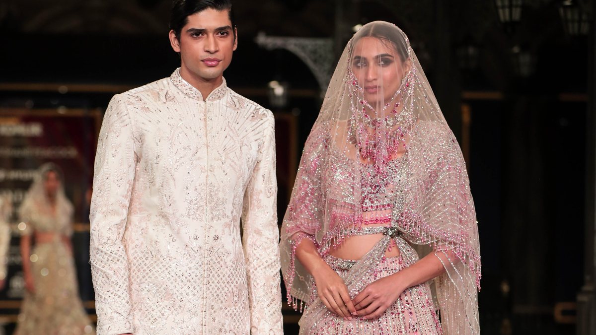 Models present creations by fashion designer Falguni Shane Peacock during the…