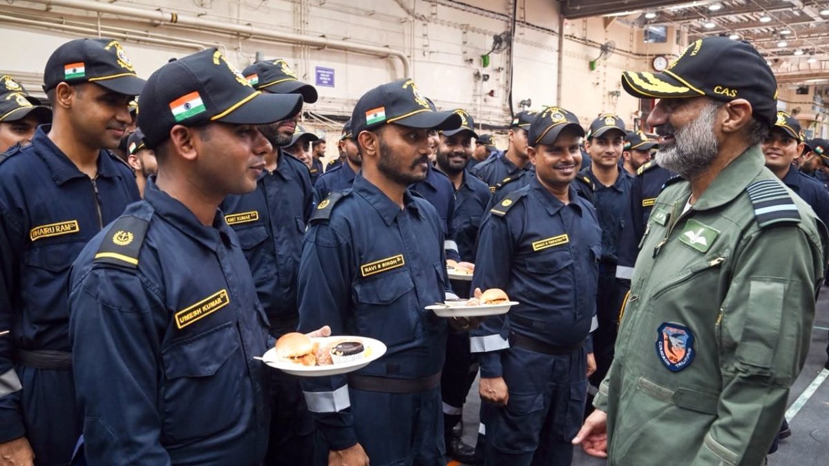 Air Chief Marshal AP Singh interacts with sailors during a meal aboard the…