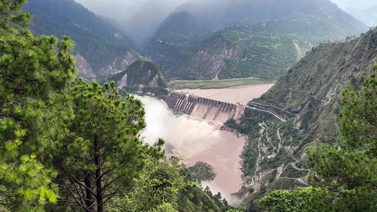 A view of the multiple opened spillway gates of the Salal Dam amid rising…
