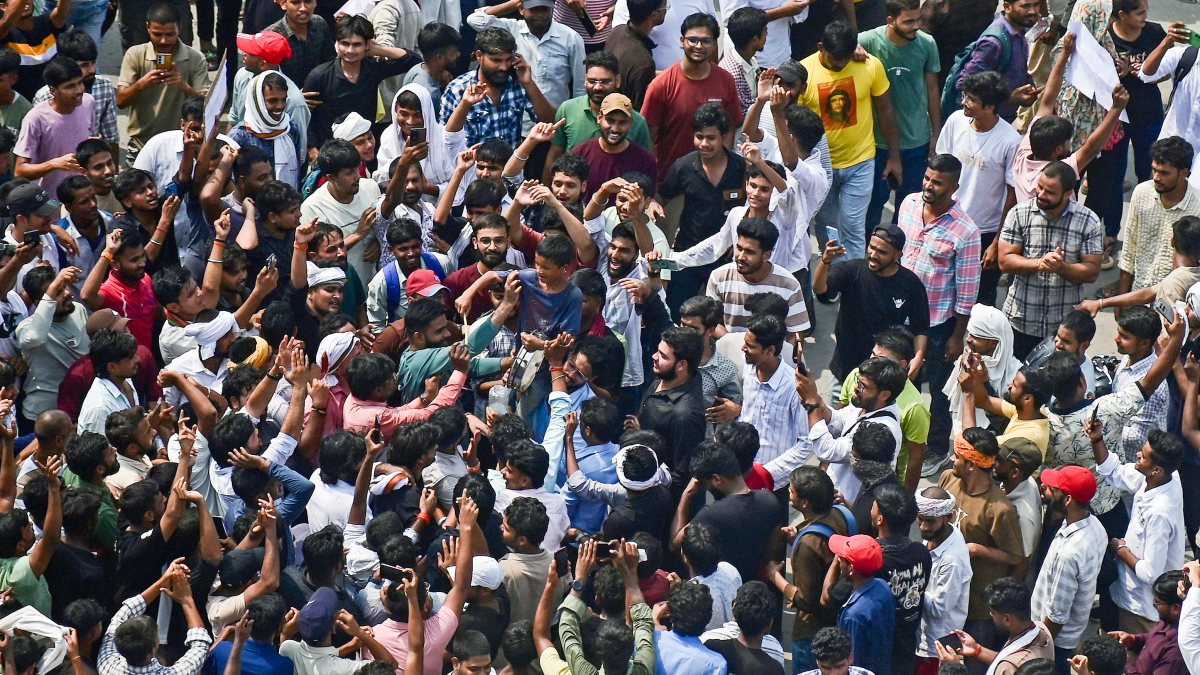 Protesters celebrate following the resignation of Union Education Minister…
