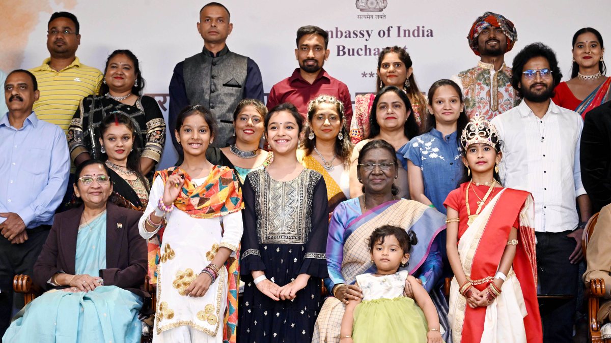 President Droupadi Murmu in a group photo with children during a reception with…