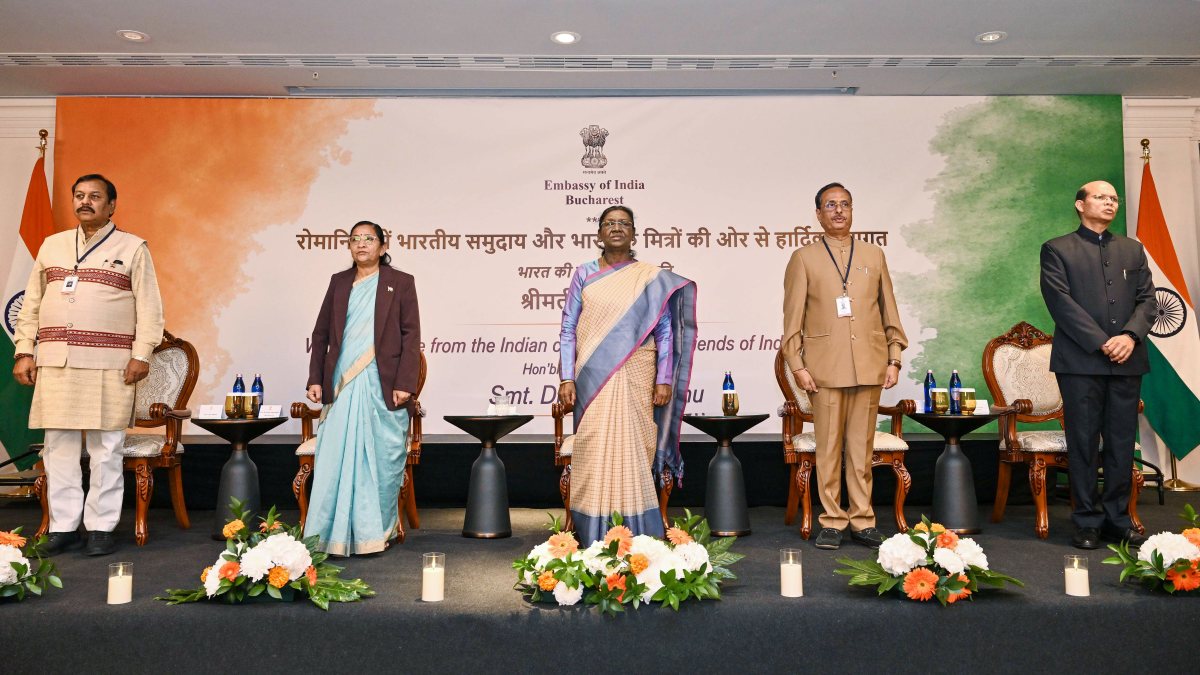 President Droupadi Murmu and others stand for the national anthem during a…