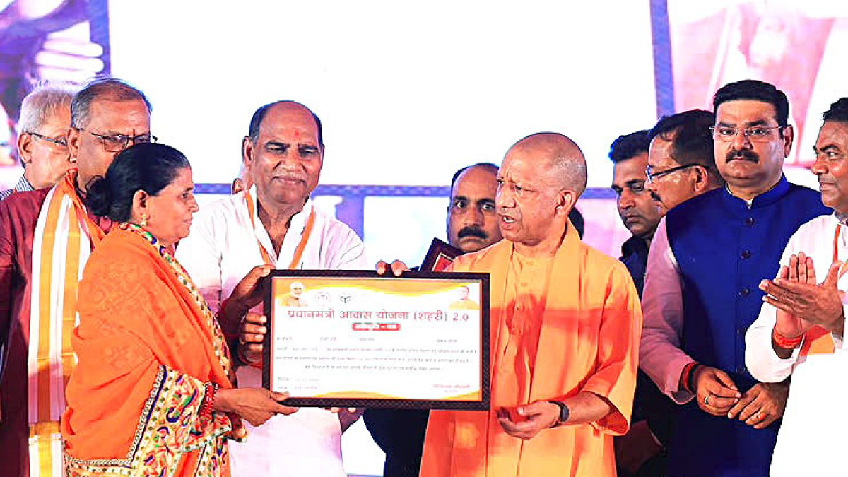 Uttar Pradesh Chief Minister Yogi Adityanath presents a PM housing scheme…