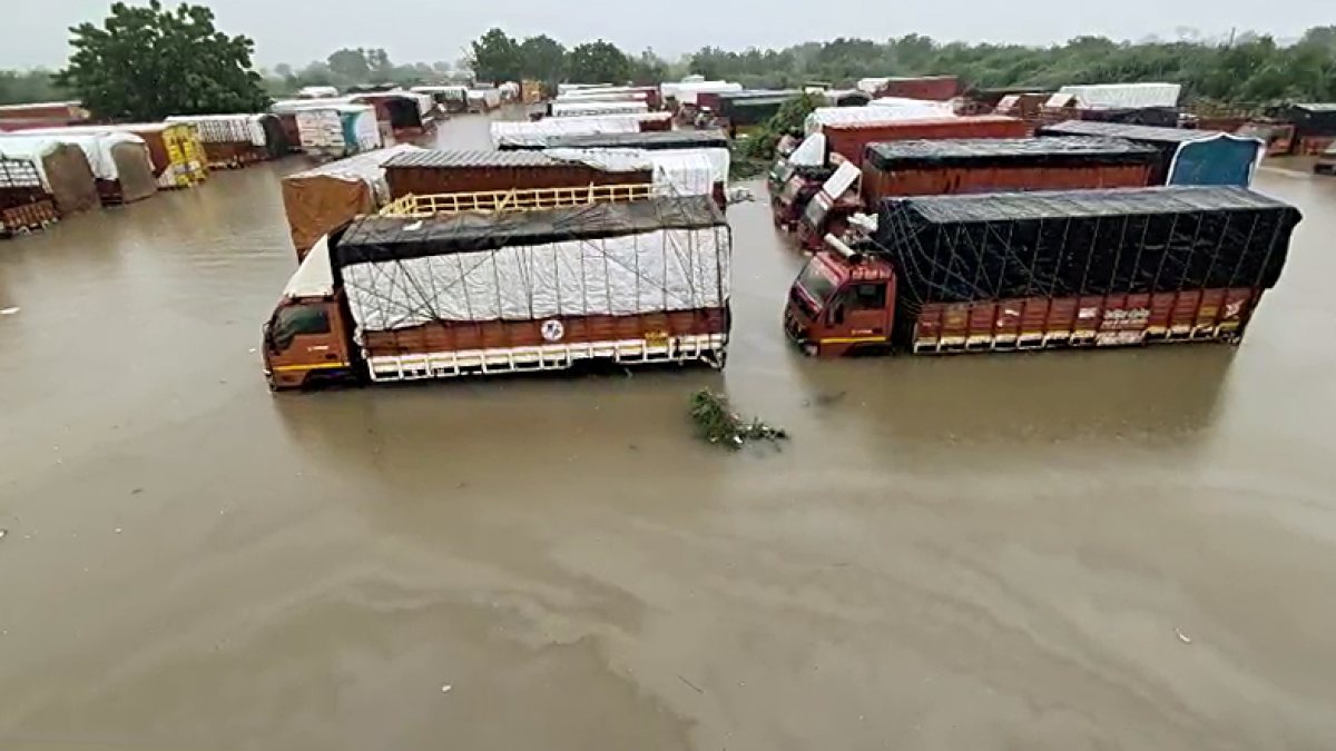 A view of the vehicles partially submerged on a waterlogged road after heavy…