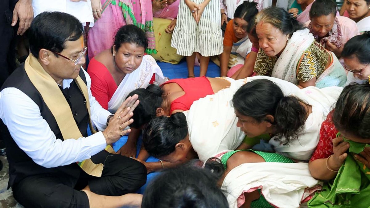 Union Minister Sarbananda Sonowal interacts with people at a relief camp during…