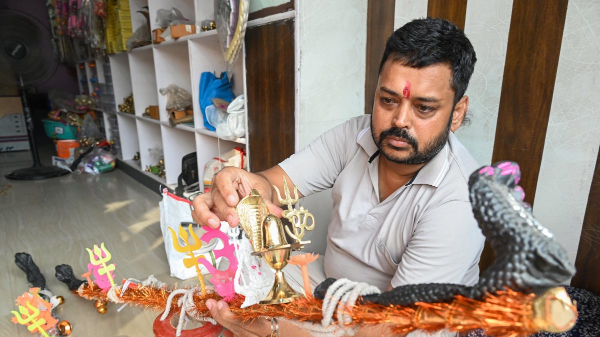 A shopkeeper prepares a Kanwar at his shop ahead of the Shravan month, in Patna…