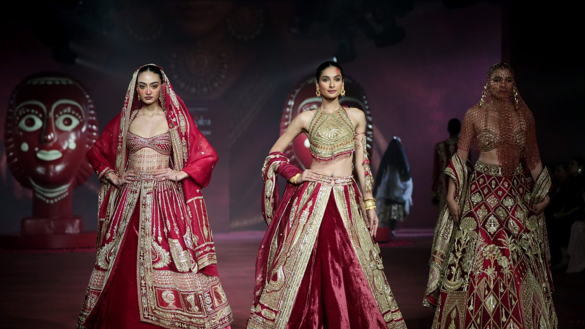 Models walk on the ramp during India couture week to showcase fashion designer…