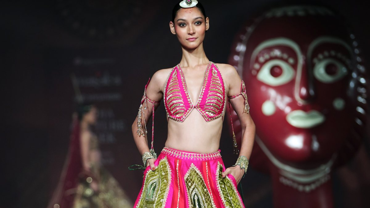 A model walks on the ramp during Day 2 of India Couture Week to showcase…