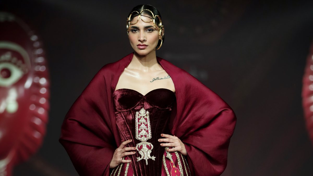 A model walks on the ramp during Day 2 of India Couture Week to showcase…