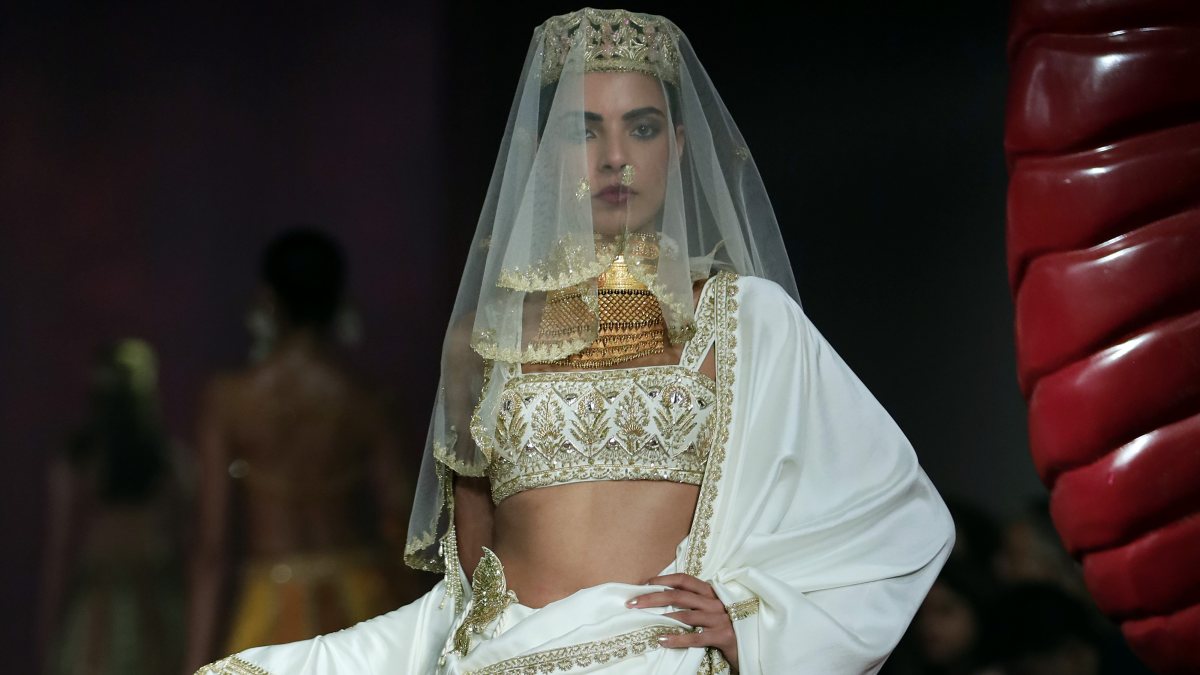 A model walks on the ramp during Day 2 of India Couture Week to showcase…