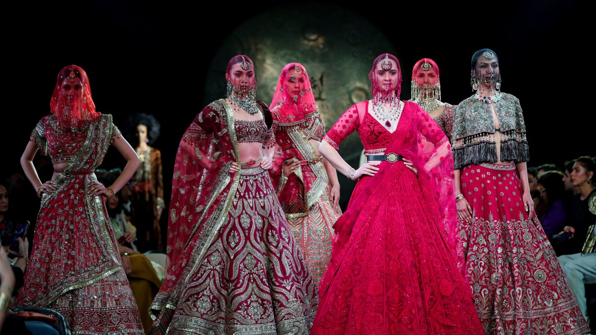 Models walk on the ramp during Day 2 of India Couture Week to showcase fashion…